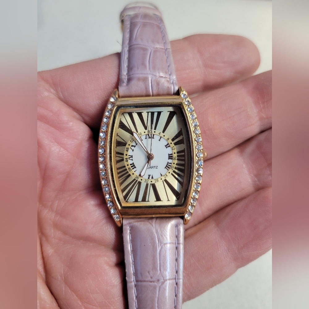 Ladies pink and gold tank style watch with diamond borders